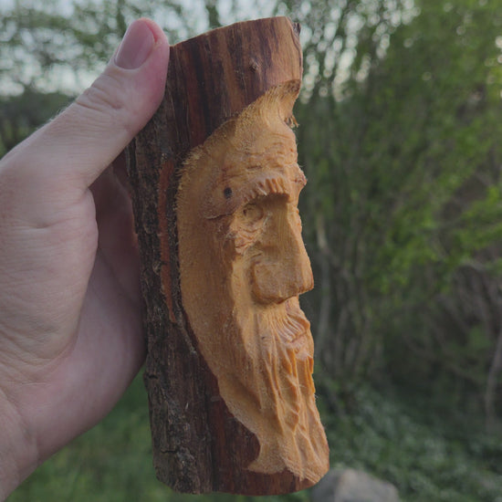 Turning video of a hand-carved cottonwood wood spirit face carving held in hand outdoors in High Rolls, New Mexico